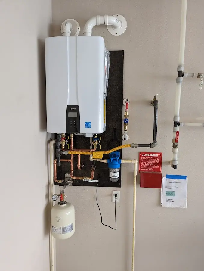 Professional plumber installing copper piping in a Ellicott City home